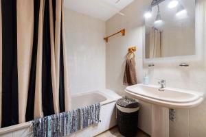 a bathroom with a sink and a bath tub and a sink at Casa Abril in L'Ampolla +19 photos
