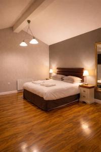 a bedroom with a bed and a wooden floor at Silverstone Golf Club And Hotel in Silverstone