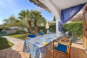 a table and chairs on the patio of a house at Casa Abril in L'Ampolla