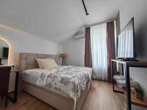 a bedroom with a bed and two windows at Motel Maks in Kiseljak +74 photos