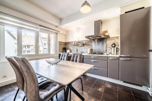 a kitchen with a table and chairs and a refrigerator at Appartement Proche Lac et Thermes in Thonon-les-Bains +18 photos