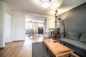 a living room with a couch and a table at Appartement Cosy Parc Thermal in Thonon-les-Bains