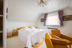 a bedroom with a bed and a table and chairs at Drevenička U Ježka in Ždiar