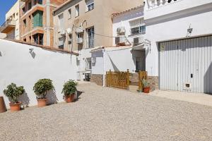 an alley with potted plants and buildings at Apartament Cristina in Deltebre