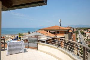 a balcony with a table and a view of a city at Residence Mediterraneo - Ombrellone incluso dal 23 maggio al 20 settembre in Marina di Grosseto