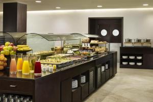 a buffet line with many different types of food at iStay by NH Ciudad de Valencia Hotel in Valencia
