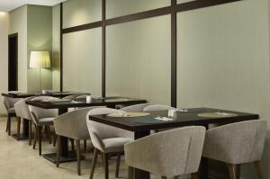 a row of tables and chairs in a restaurant at iStay by NH Ciudad de Valencia Hotel in Valencia