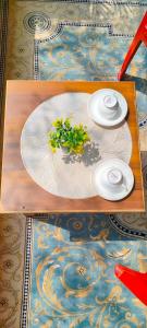 a wooden table with two plates on top at ayodhya homestay in Faizābād
