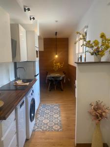a kitchen with a washing machine and a dining room at Estavar in Estavar