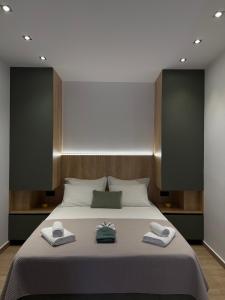 a bedroom with a bed with two towels on it at Nido Estivo 2 in Nea Skioni