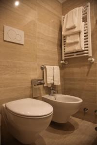 a bathroom with a toilet and a sink and towels at B&B Federica's House In Rome in Rome