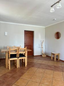 a dining room with a wooden table and benches at Vaivari Retreat in Jūrmala