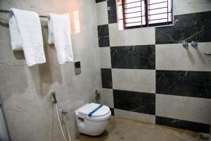 a bathroom with a toilet and a shower at Safa residency hotel in Perintalmanna