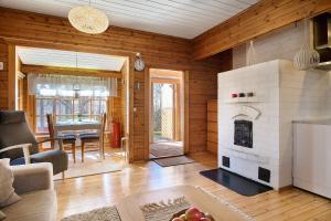 a living room with a fireplace in a house at Holiday Cabin Kukkula - AC, fireplace & wood-fired sauna in Porvoo