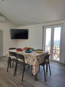 a dining room table with chairs and a tablecloth on it at Casa Zia Maria in Pollina