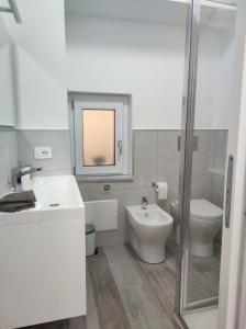 a bathroom with a sink and a toilet and a shower at Casa Zia Maria in Pollina +54 photos