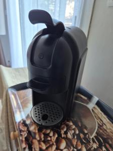 a black coffee maker sitting on top of coffee beans at Chez Hélène in Bordeaux