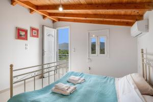 a bedroom with a bed and a balcony at Angelina's Cute House in Neapoli Voion
