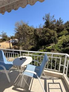 a table and two chairs on a balcony at Helios in Kavála +10 photos
