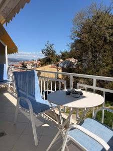 a table and two chairs on a balcony at Helios in Kavála
