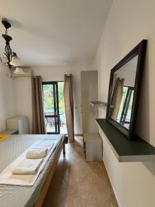 a bedroom with a bed with a mirror and a table at Apartments Regata in Ulcinj