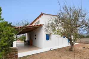 a white house with a red roof at Angelina's Cute House in Neapoli Voion