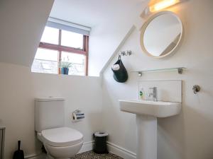 a bathroom with a toilet and a sink and a mirror at Apartments in Dingle Town Center in Dingle +59 photos