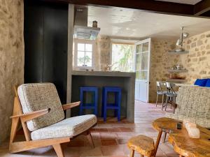 a living room with two chairs and a fireplace at Domaine de Ribaute in Lieuran-lès-Béziers