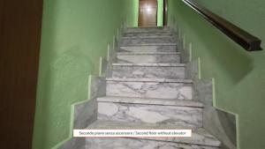 a stairway with a stone staircase with green walls at Arlecchino - By Turent in Pietra Ligure