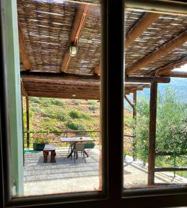 a view from a window of a patio with a table at Stone Kypri Apartment Andros in Kipri +22 photos