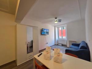 a living room with a table and a blue couch at Arlecchino - By Turent in Pietra Ligure