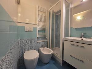 a bathroom with a toilet and a sink at Arlecchino - By Turent in Pietra Ligure