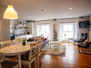 a kitchen and living room with a table and chairs at Apartments in Dingle Town Center in Dingle