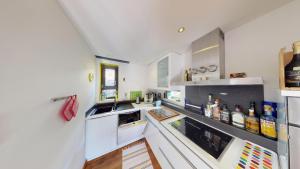 a kitchen with white cabinets and a sink at Tschuggen TU14 in Blatten bei Naters +13 photos