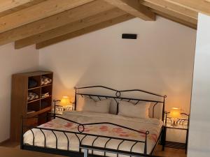 a bedroom with a bed with a black metal frame at Bubo House in Črni Kal