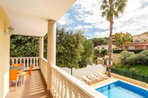 a balcony of a house with a swimming pool at Villa Florida in Lloret de Mar