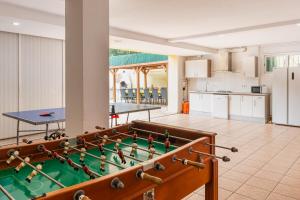 a room with a pool table and a kitchen at Villa Florida in Lloret de Mar
