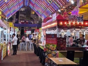 a food court with tables and people walking around at Baan Rak BTS phromphong Emsphere in Bangkok +89 photos