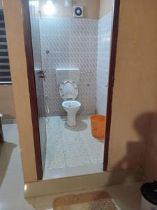 a bathroom with a toilet in a shower stall at Safa residency hotel in Perintalmanna +12 photos