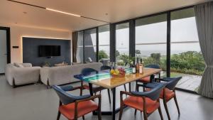 a living room with a table and chairs and a couch at Beyond by Sula in Nashik