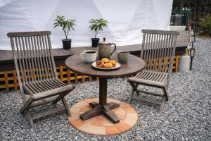 a table with two chairs and a plate of food on it at 摩天轮下的森 in Tsumagoi