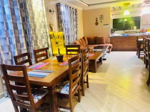 a dining room and living room with a table and chairs at Villa Serene Hotel in Kitale
