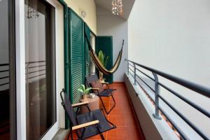 a balcony with two chairs and a hammock at Casa da Rosa by Mth in Porto Santo