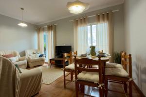 a living room with a table and chairs and a couch at Casa da Rosa by Mth in Porto Santo