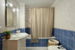a bathroom with a sink and a shower and a toilet at Casa da Rosa by Mth in Porto Santo +20 photos