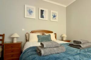 a bedroom with a bed with towels on it at Casa da Rosa by Mth in Porto Santo