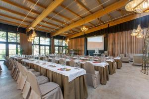 a banquet hall with tables and chairs and a screen at Hotel Luze El Toro in Berrioplano