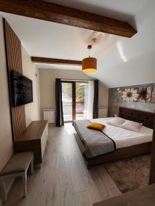 a bedroom with a large bed and a window at Garden Apart in Predeal
