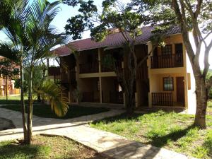 a building with trees in front of it at Pousada Alto do Bau in Conceição do Mato Dentro