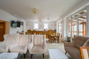 a living room with chairs and a dining room at Apartmany U Jezka in Ždiar